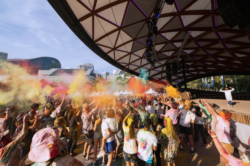 an event photo of colors being thrown during Holi Festival at Darling Harbour Sydney Australia