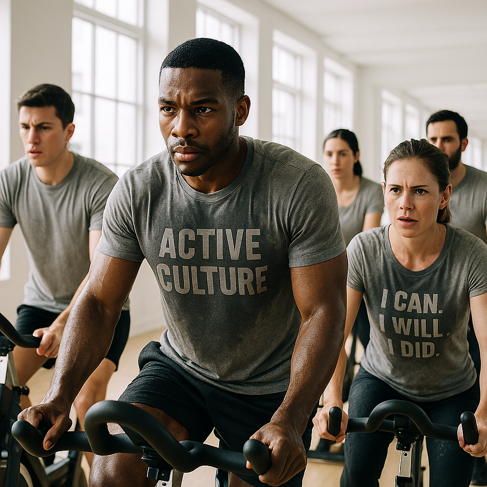 Man sweating during indoor cycling workout wearing a gray Active Culture sweat-activated shirt revealing bold logo