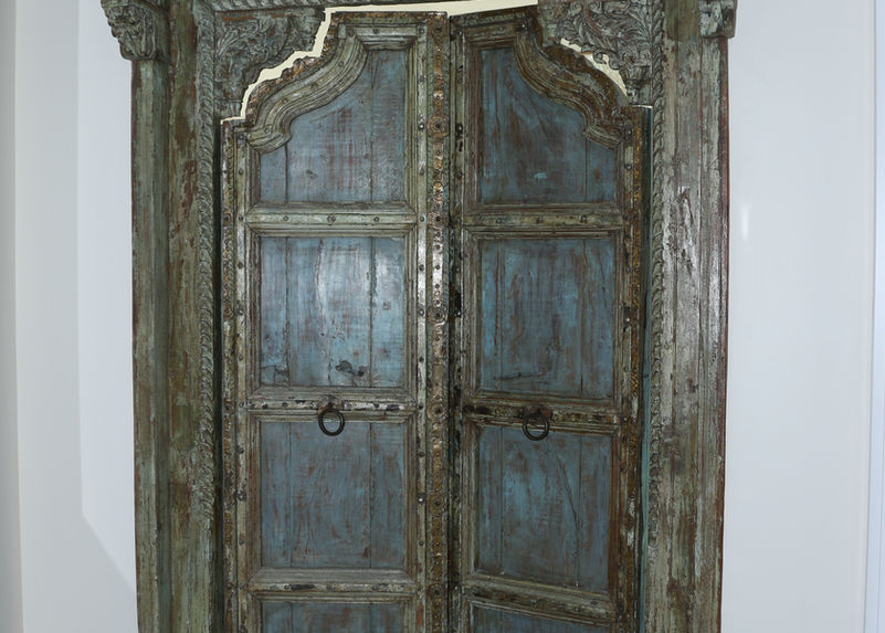 Custom made doors lead you to the primary bedroom designed by Devon Rose Interiors 