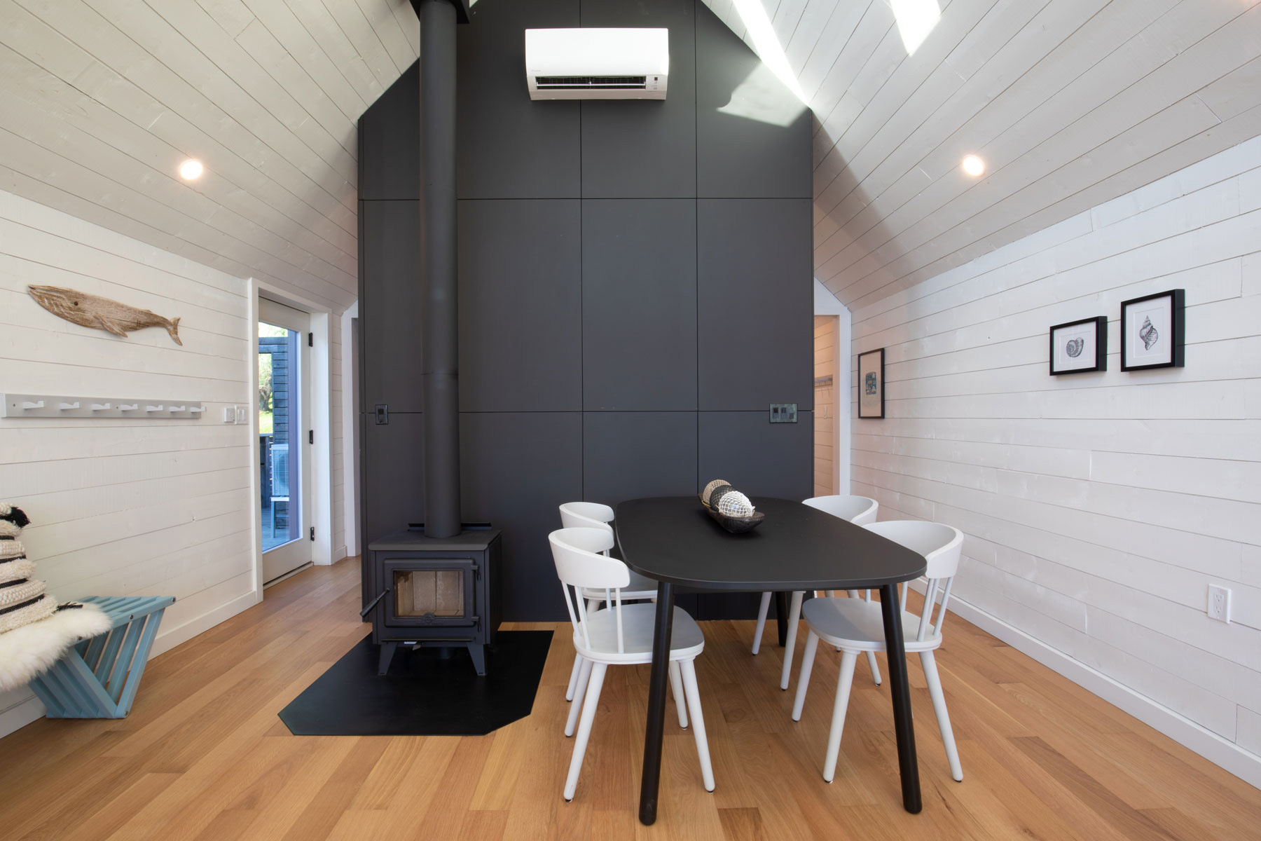 Modern interior architecture design with horizontal boards and vaulted ceiling in Nova Scotia designed by Nicholas Fudge Architects. 