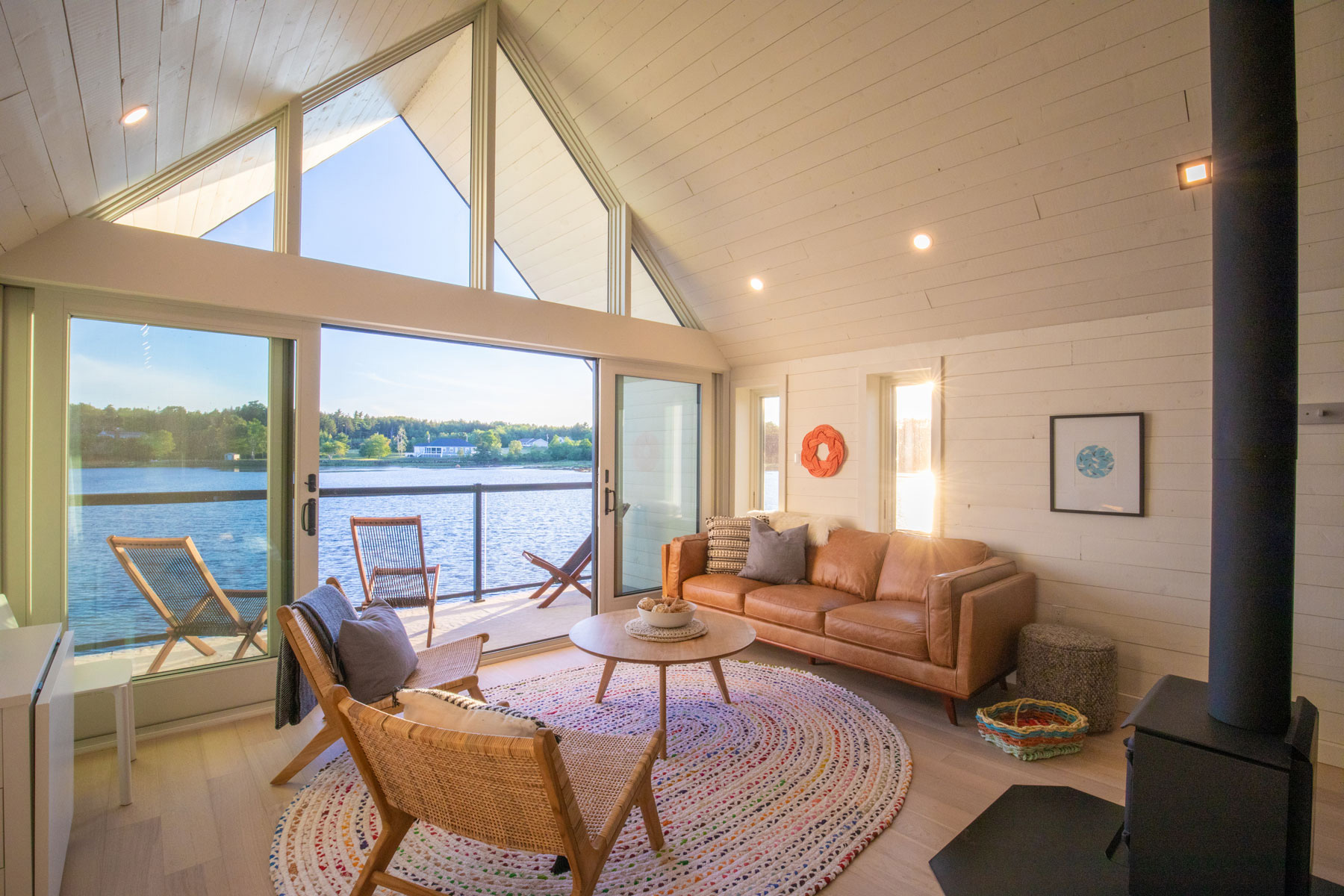 Modern architecture interior with white horizontal wood boards on vaulted ceiling in Nova Scotia designed by Nicholas Fudge Architects. 