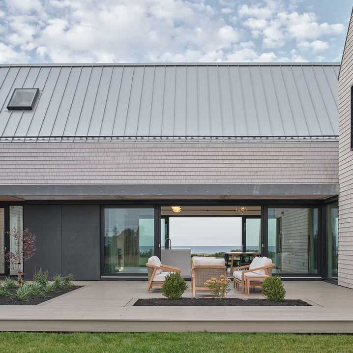 Modern architecture house with cedar shingles and outdoor courtyard located in Nova Scotia designed by Nicholas Fudge Architects.