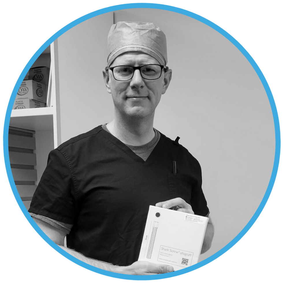 Surgeon holding a Shark Screw product box