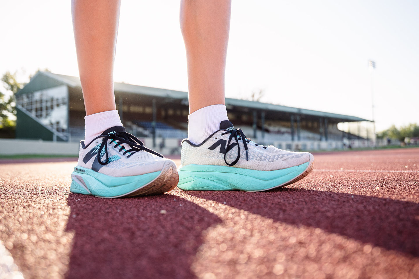 Close-up of running shoes on a red track surface, photographed by a running photographer in Cape Town.