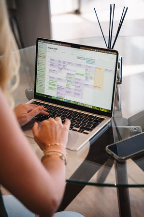 Woman working at laptop workspace personal branding portrait with office supplies – executive photographer Cape Town