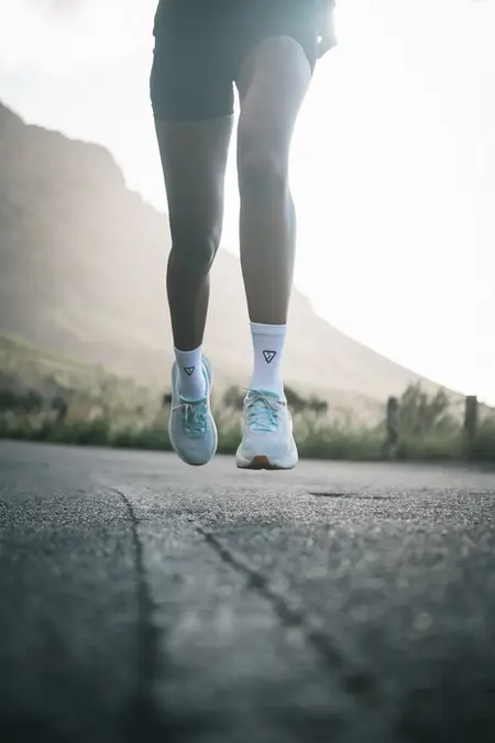 Low-angle detail of running shoes mid-stride during a Cape Town session