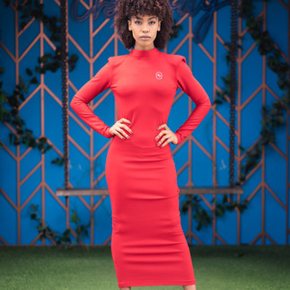 Model standing confidently in a red dress during a vibrant editorial-style personal branding shoot in Cape Town
