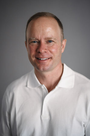 Friendly professional headshot man in light shirt genuine smile – authentic personal branding Cape Town