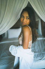 Side profile of model in lingerie looking over shoulder, sleepwear campaign photography.