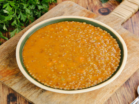 plate of Lentil Soup on a wood cutting board