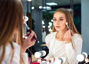woman-applying-powder-in-mirror.jpg