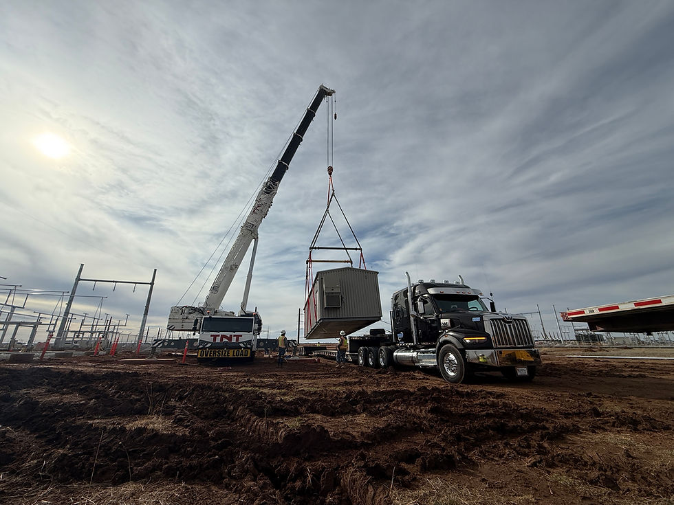 Crane loading an enclosure onto one of our trailers