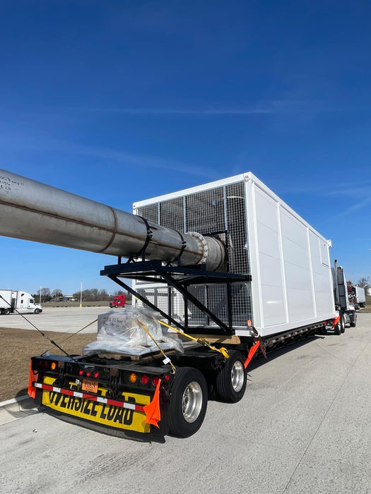 Load being hauled on a flatbed trailer.