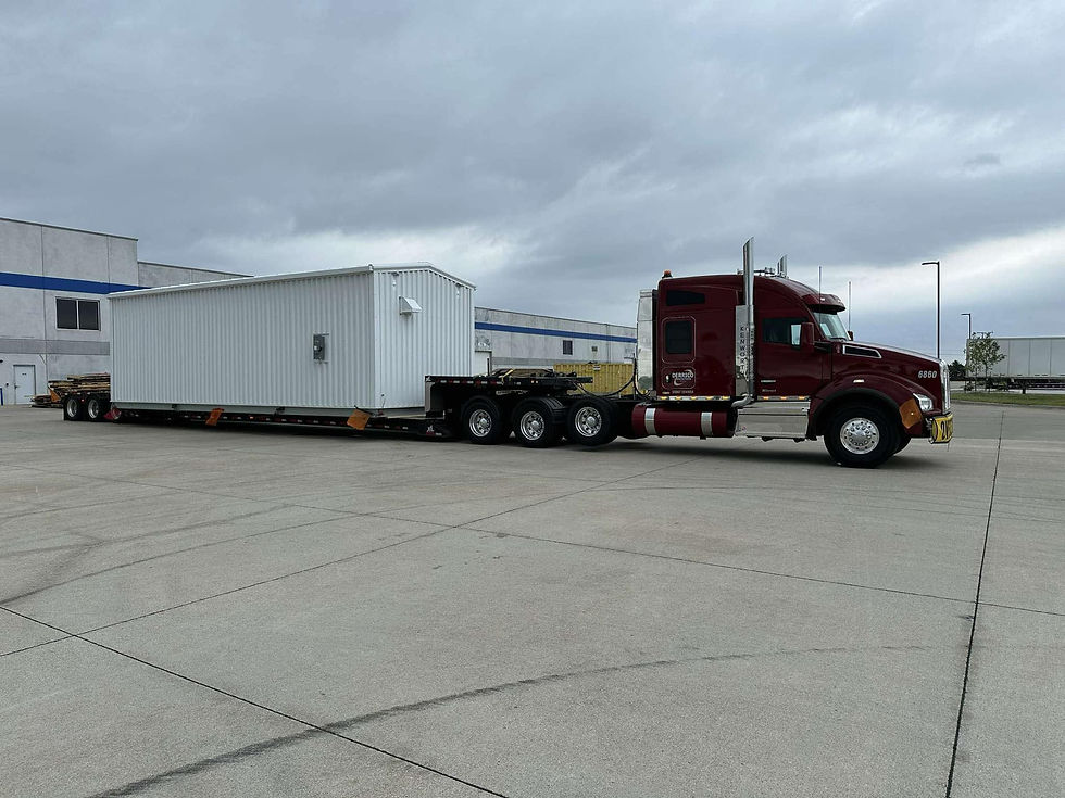 Maroon semi hauling a load on a double drop trailer.