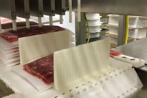 The Razorback Meat Stacker Stacks of meat after they come through the interleaver to make packaging faster and more efficient..