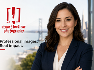 Professional woman in a navy blazer against a softly blurred San Francisco waterfront backdrop, with Stuart Locklear Photography branding.
