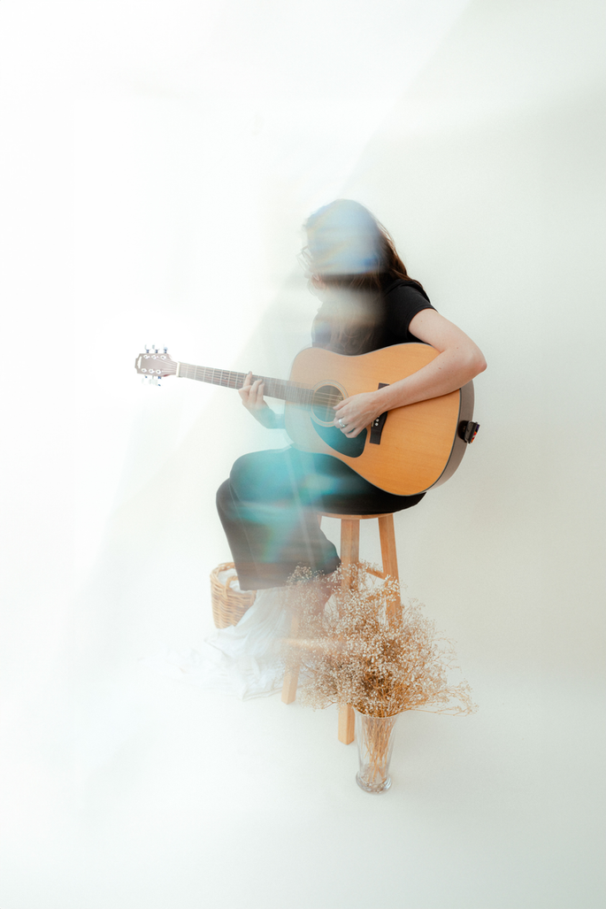 Editorial wedding photography portrait of a guest playing guitar, photographed on film with creative light leaks by an Arizona film wedding photographer