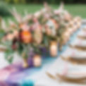 a beautiful wedding table with flowers and a custom printed fluid art table runner .jpg