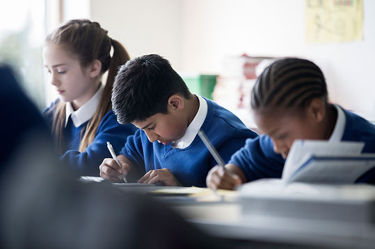 Three children working in a classroom