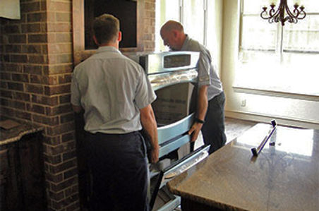 Appliance Technicians Installing a Wall Oven