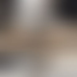 Close-up of custom arcade cabinet being built in a workshop — woodworking tools and monitor frame in progress.