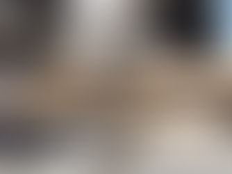 Close-up of custom arcade cabinet being built in a workshop — woodworking tools and monitor frame in progress.