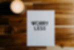 Worry less sign on table next to coffee