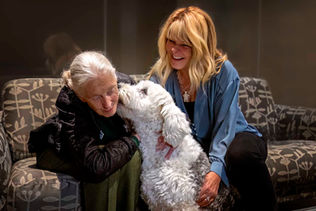 Michelle Valberg and Jane Goodall exchanging Ginni (Michelle's old English sheepdog) love