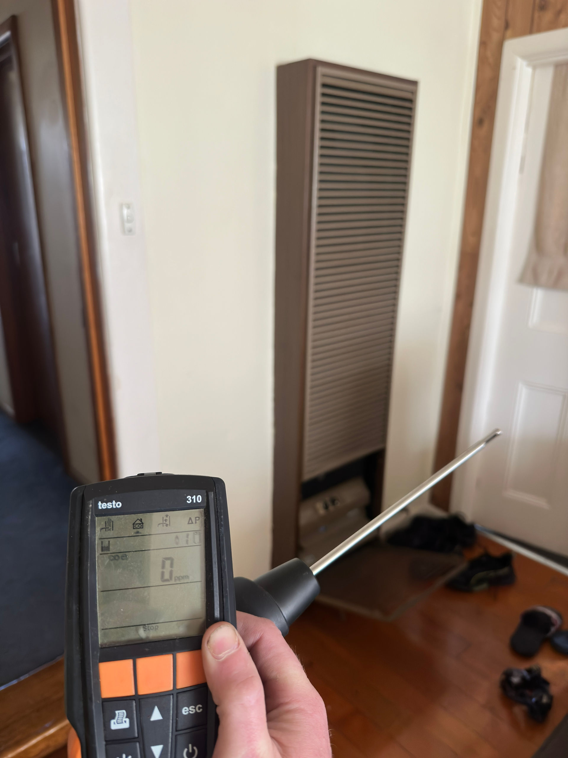 ATC Plumbing conducting a carbon monoxide test on gas heater