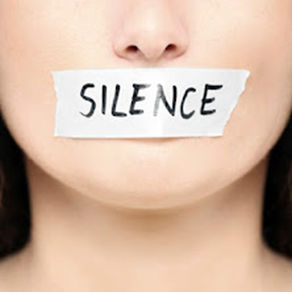 A woman with tape over her mouth with SILENCE written on it