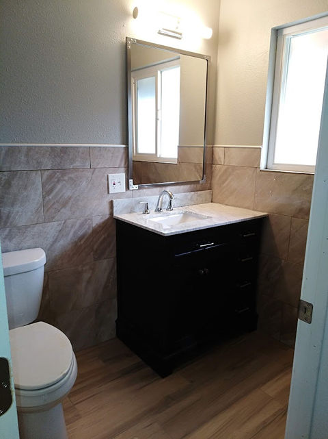 remodeled bathroom with wall porcelain wall tiles, tile floors new toilet, mirror &vanity Calaveras, Ca