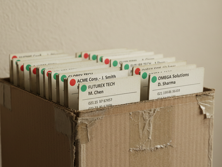Wide-angle view of a weathered box filled with labelled contact cards