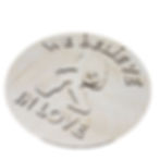 Round wooden sign: "We Believe In Love"