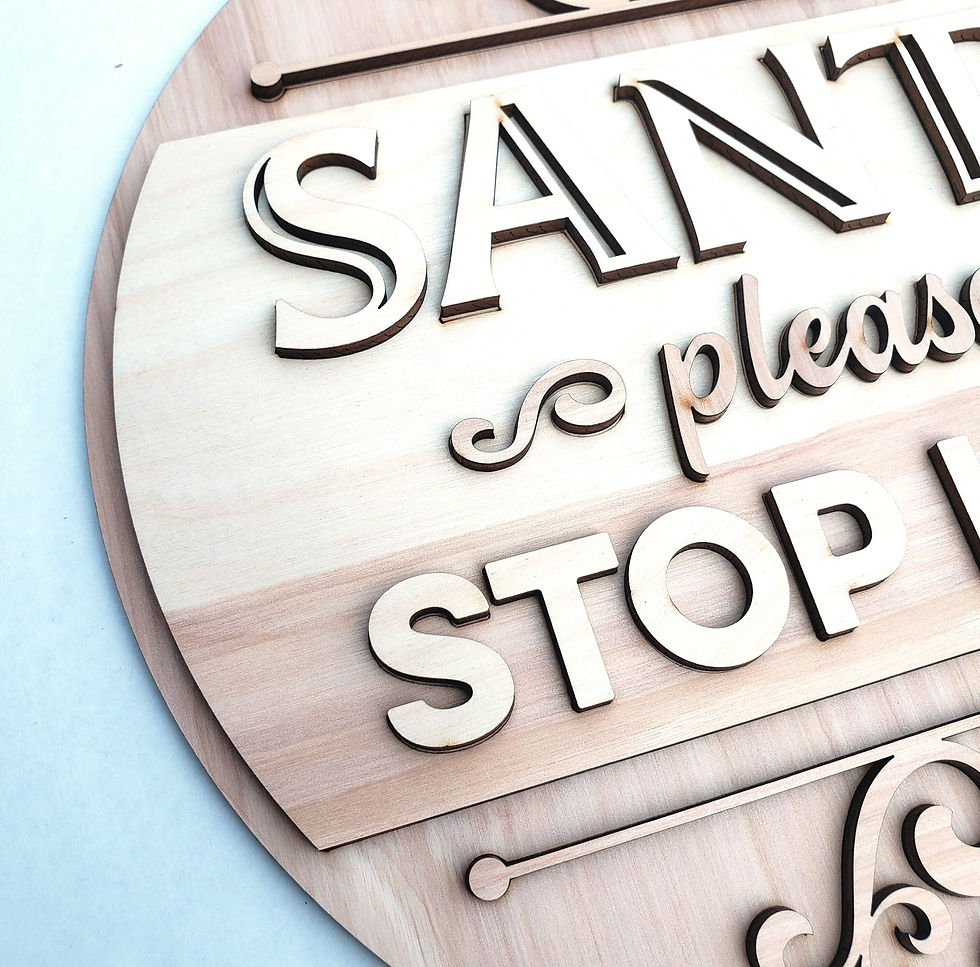 Round wooden sign: "Santa please stop here"