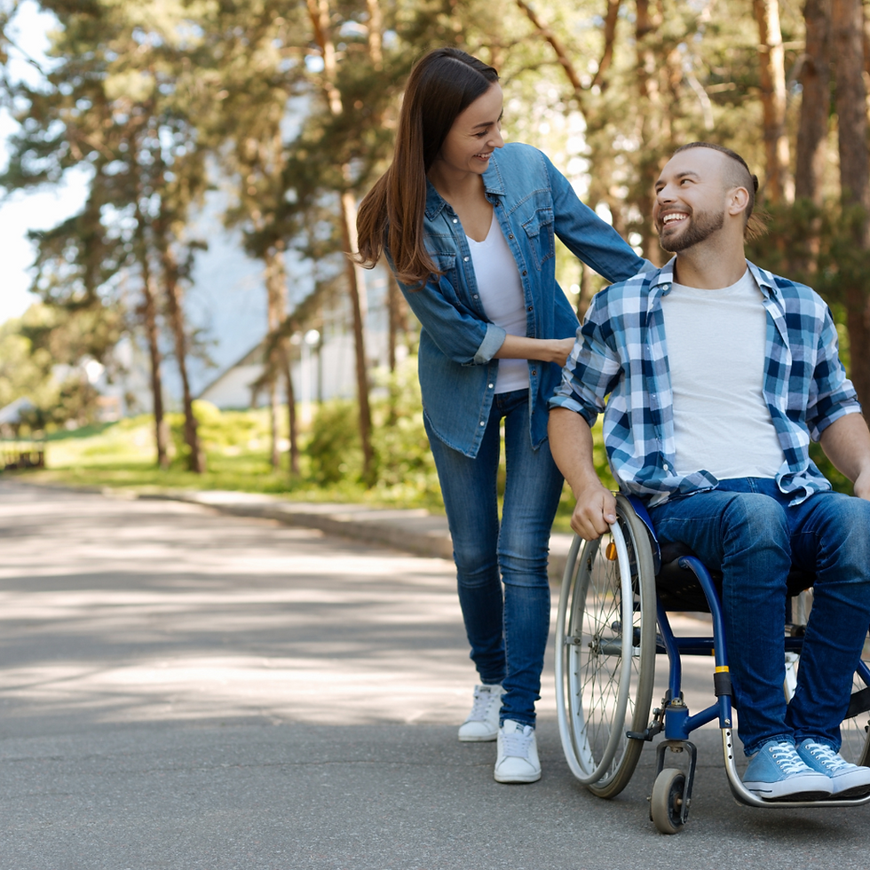 Support worker helping a man in a wheelchair - Quality Health Care