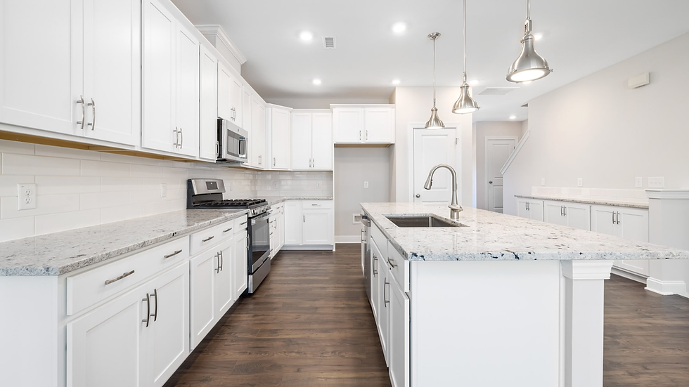 Modern Northeast Ohio kitchen remodel featuring white shaker cabinetry, oversized island, granite countertops, stainless steel appliances, and an open layout designed to add value for homeowners and real estate investors.