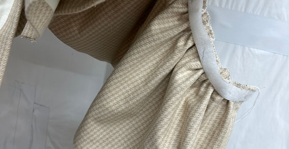Ruffled bed skirt in tan and cream houndstooth print in progress at Rideaux Designs' workroom