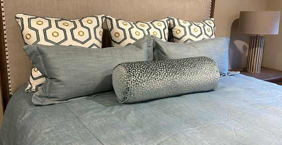 Custom bedding ensemble with teal and gold solids, geometric and animal print, including duvet cover, shams, bolster, and euro pillows by Rideaux Designs