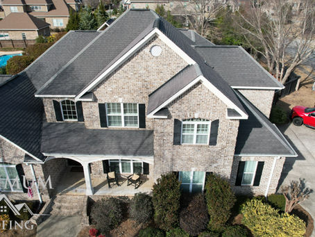 Aerial dusk view of a completed residential roof replacement by Optimum Roofing Co. serving Powder Springs, GA