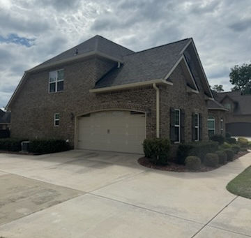 Front exterior view of a well-maintained Dallas, GA home with a sturdy asphalt shingle roof, the kind of storm-ready installation Optimum Roofing Co. provides