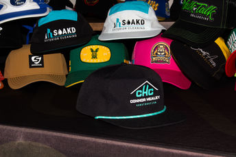 Caps with embroidered and patch logos photographed together