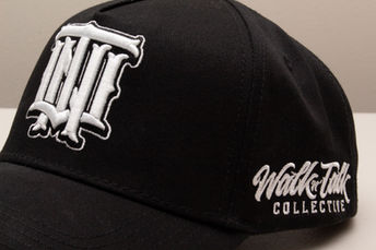 Black cap showing the Walk n Talk Collective logo on the side