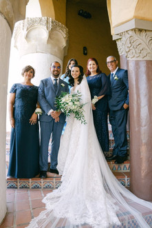 Bride, groom and family posing.