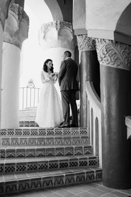 Bride and groom posing in the Santa Barbara courthouse stairwell.