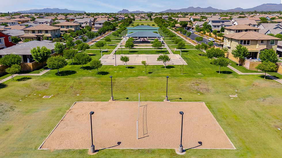 Aerial view of residential park with volleyball court and homes
