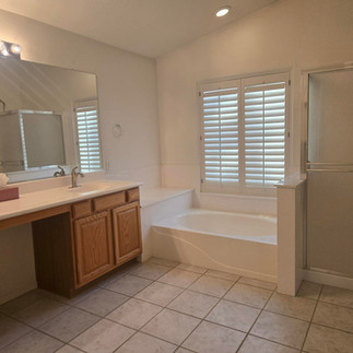 Bathroom with large vanity, built-in tub, and walk-in shower