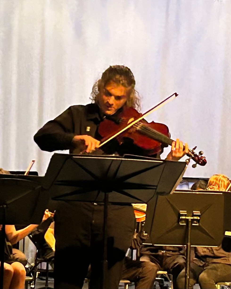 A photo of Sullivan playing their viola