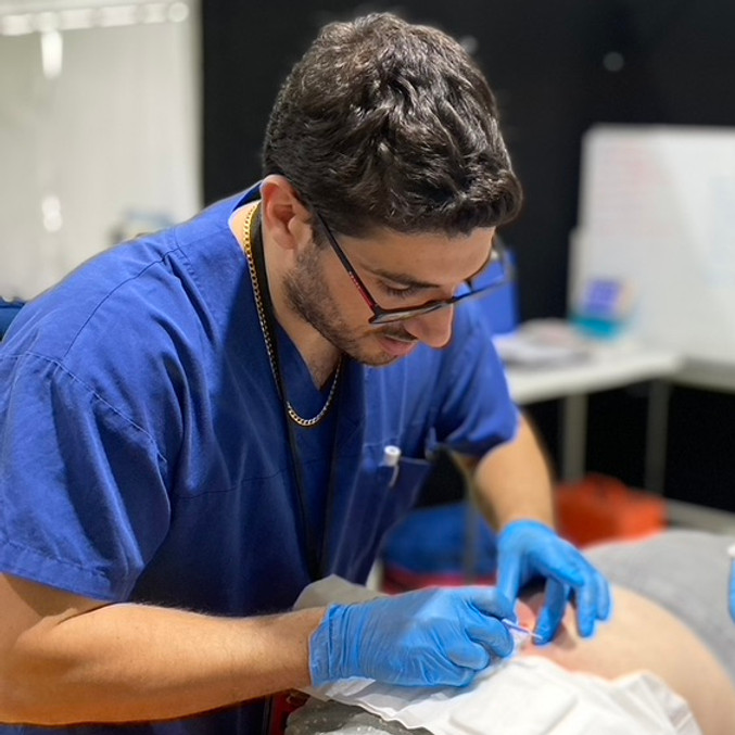 A doctor performs a procedure on a mannequin
