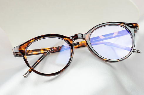 leopard colored glasses on a white silk fabric