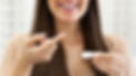 woman holding a contact lens on her finger